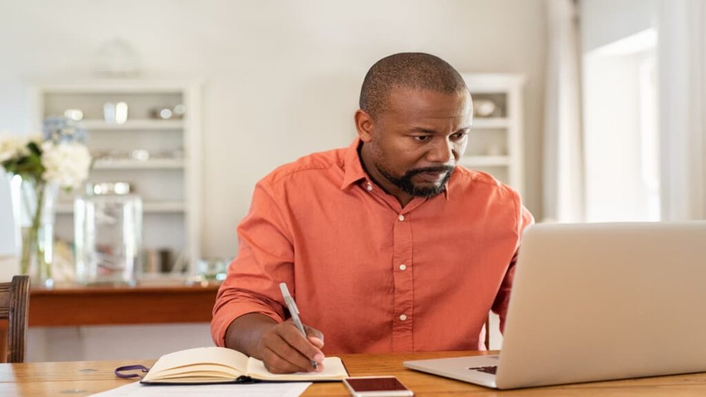 man with red shirt studying