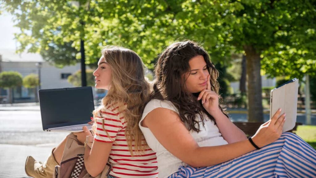 two girls studying outside