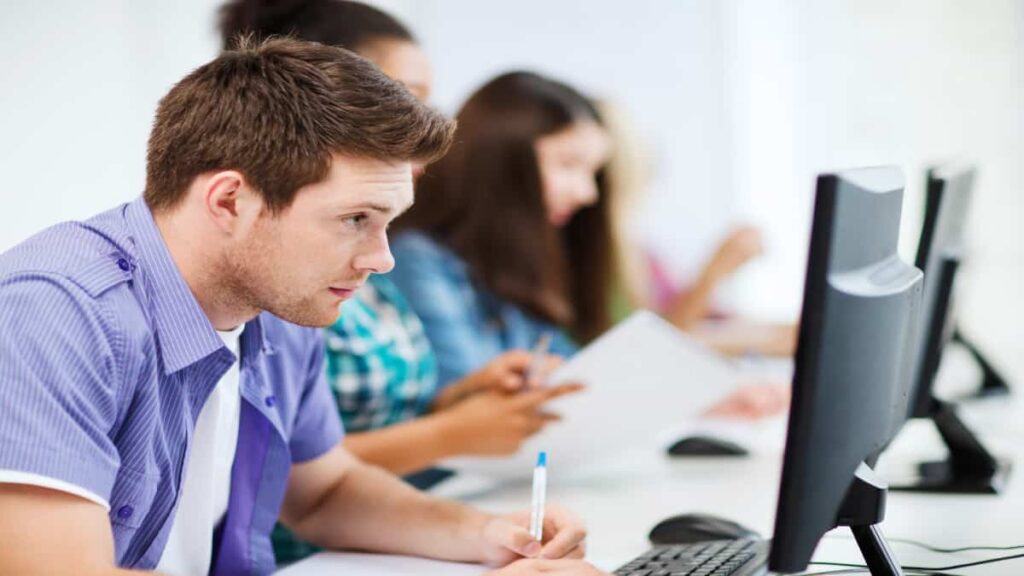 Young guy studying on computer