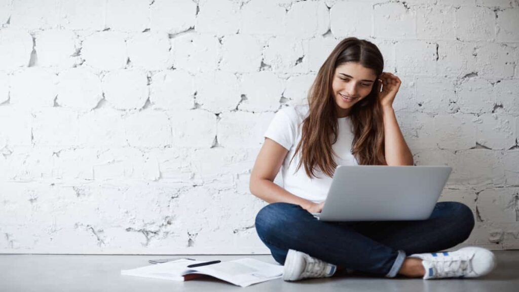 Woman studying with a laptop on her lap