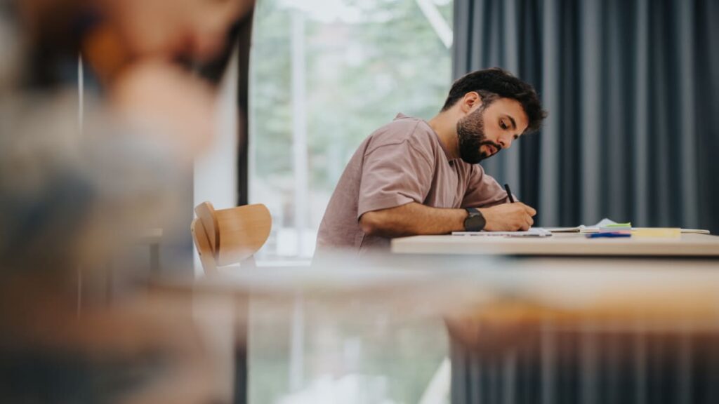 Man studying and writing