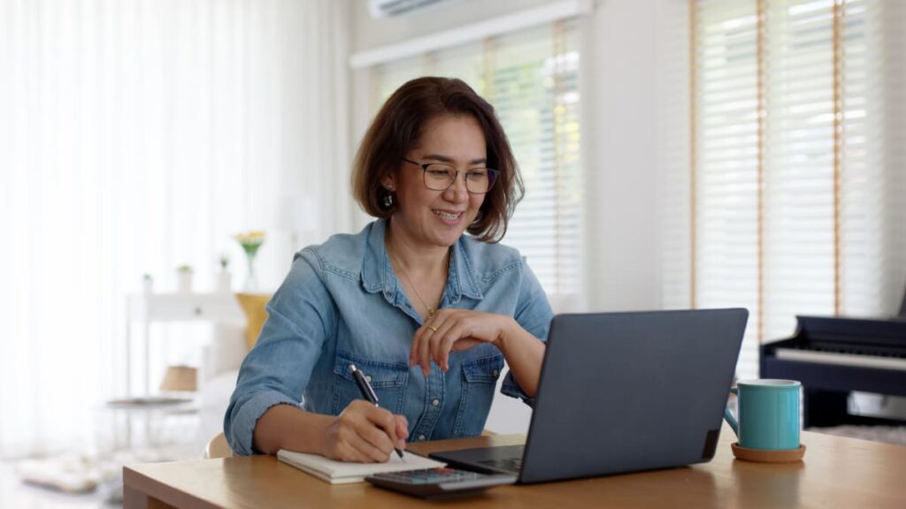 woman with glasses and a computer